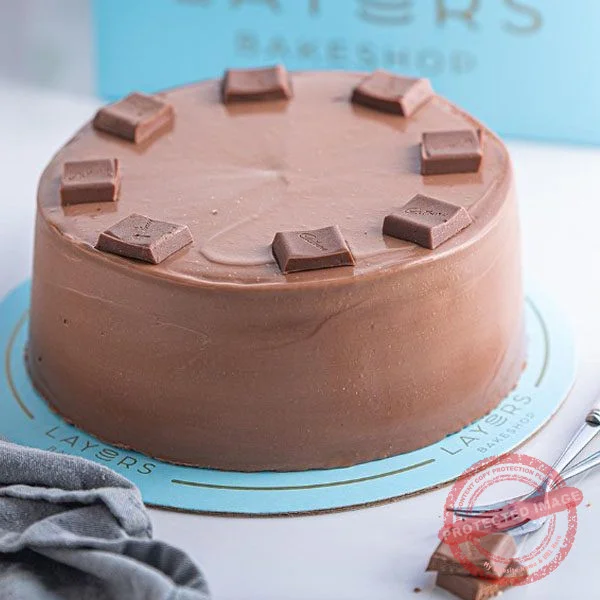 Layers Bakeshop Dairy Milk Cake with creamy milk chocolate decoration Layers Bakeshop Dairy Milk Cake with creamy milk chocolate decoration